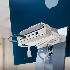 Twelve South BackPack 4 monitor shelf mounted behind an iMac with cables and a device on top