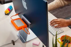 Twelve South BackPack 4 shelf mounted on iMac with an external drive and USB-C cables on the back