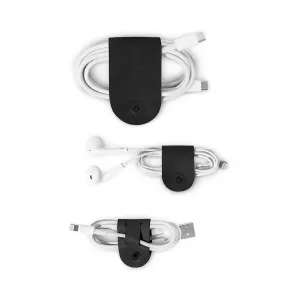 Twelve South CableSnap kabelhållare i svart läder med lindade USB- och hörlurssladdar