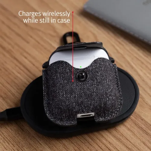 Twelve South AirSnap Twill case for Apple AirPods on a wireless charging pad, with clip and snap closure.